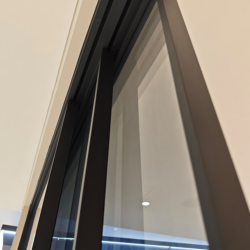 Close-up of the WT-103 head rail and black-framed glass panels.