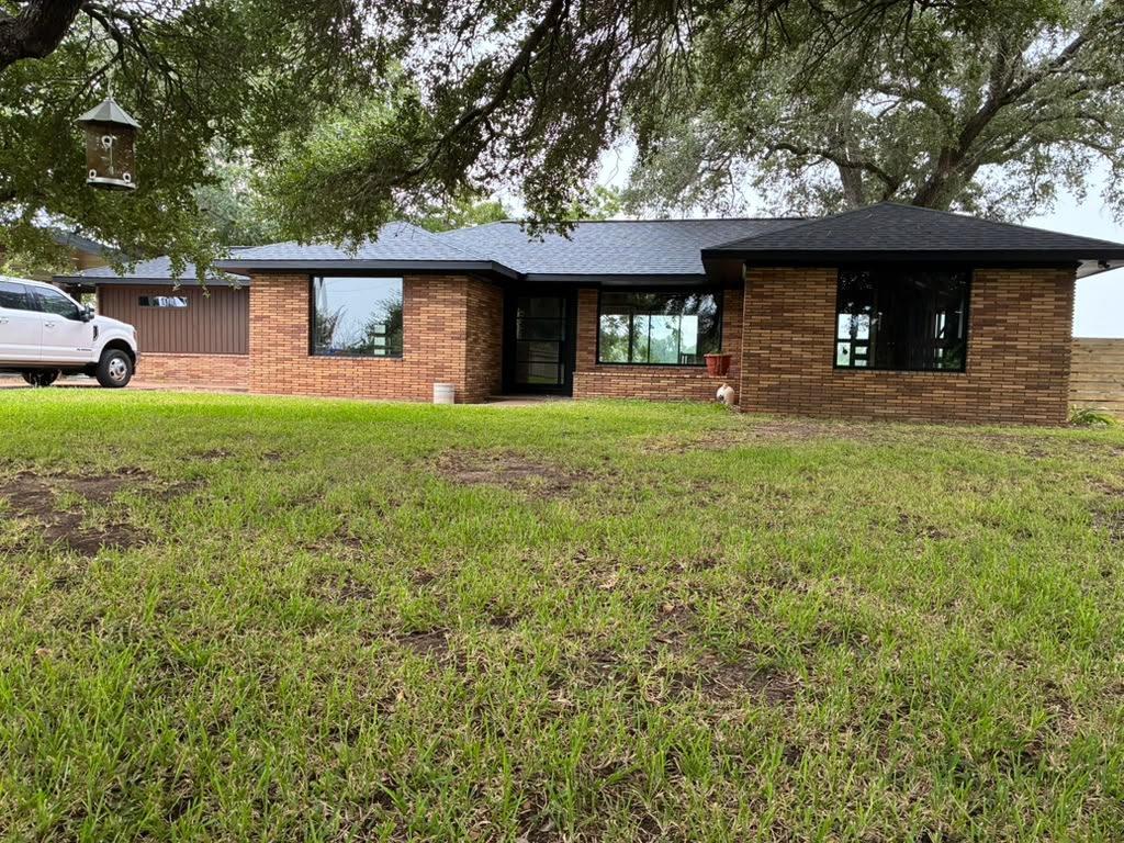 Updated side elevation with dark-framed windows and a modern roof 