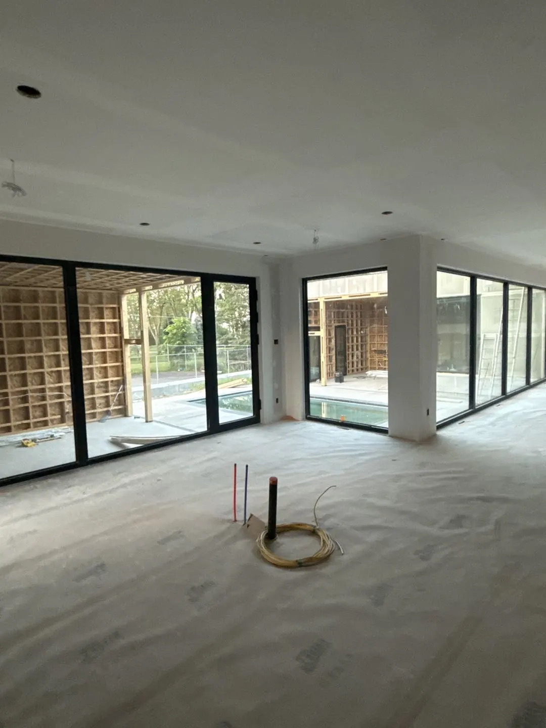 Wide view of aluminum sliding door system and fixed glass windows in modern residential villa