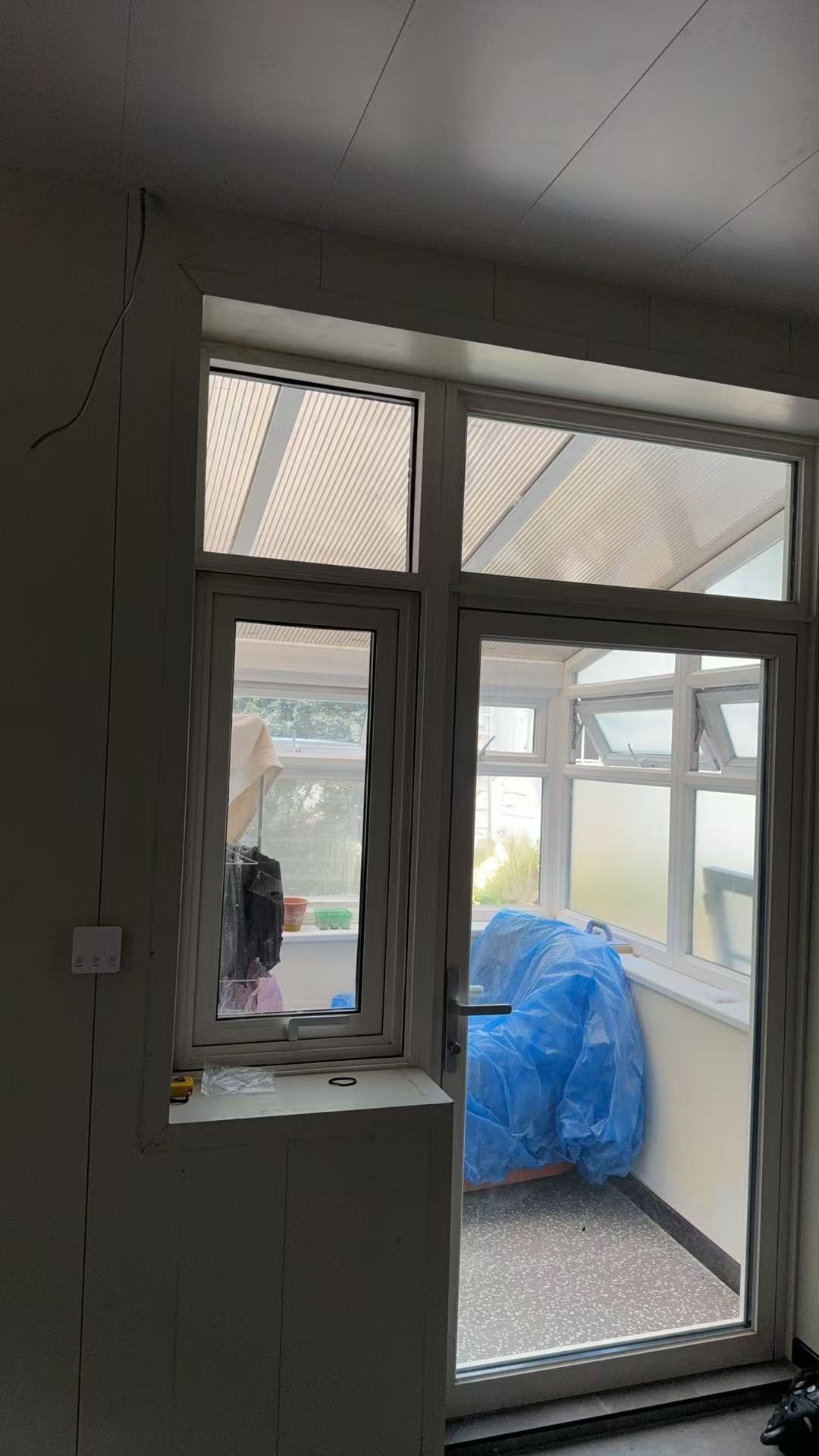 Interior glass door and transom window system for a Jersey Island home