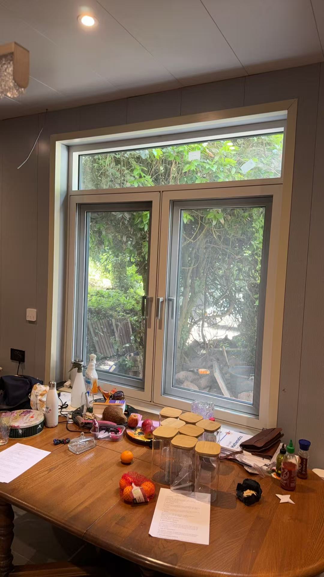 Interior casement windows with transom window and garden view